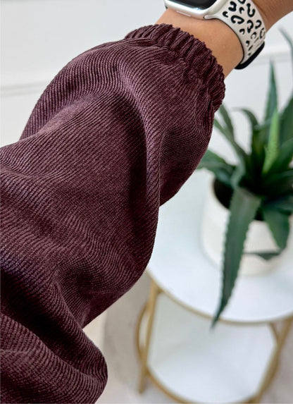 Brown knitted sweater with a blurred background