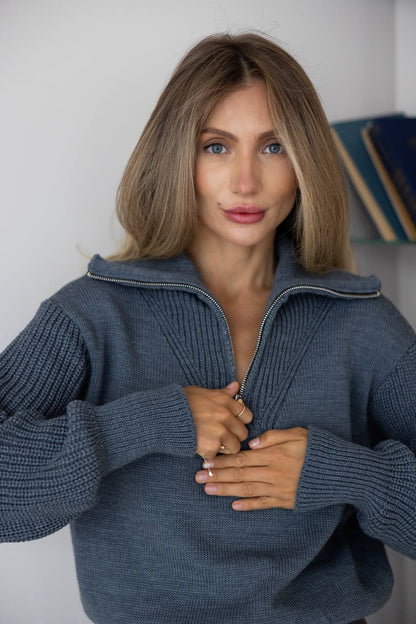 Woman wearing a blue sweater against a neutral background