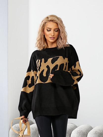 Woman wearing a black sweater with a leopard print pattern on a white background
