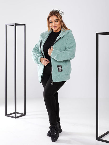Woman wearing a light blue fleece jacket on a white background
