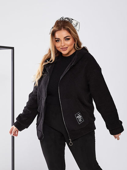 Woman wearing a black outfit with a hood and a visible brand logo on a white background