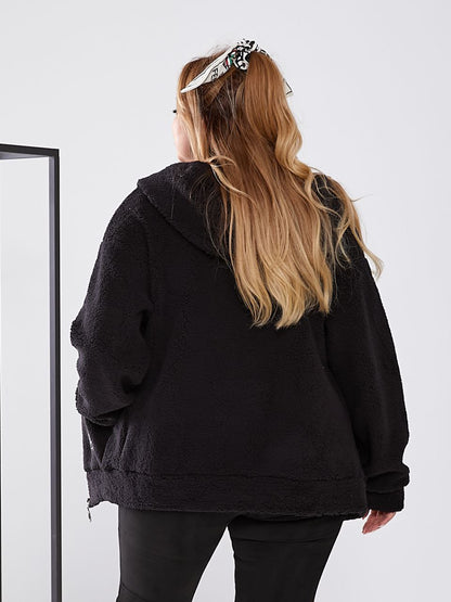 Person wearing a black hoodie from behind with a plain white background