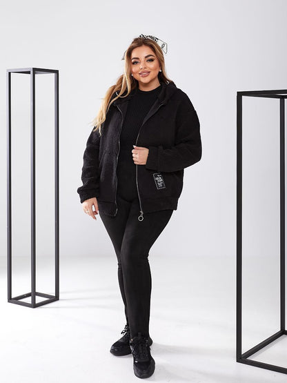 Woman wearing a black outfit with a white background