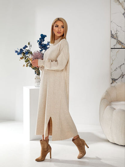 Woman in a beige dress holding flowers in a minimalistic setting