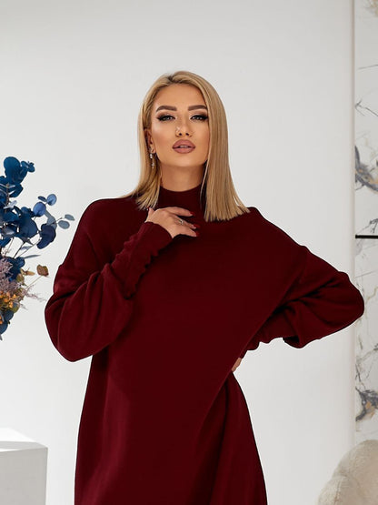 Woman wearing a burgundy dress against a white background