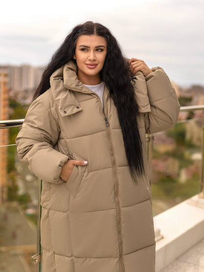 Woman wearing a beige puffer coat on a rooftop with a cityscape background