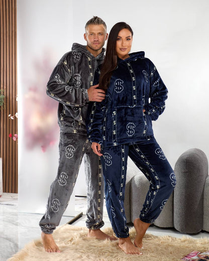 Two people wearing matching pajama sets with a brand logo in a living room.