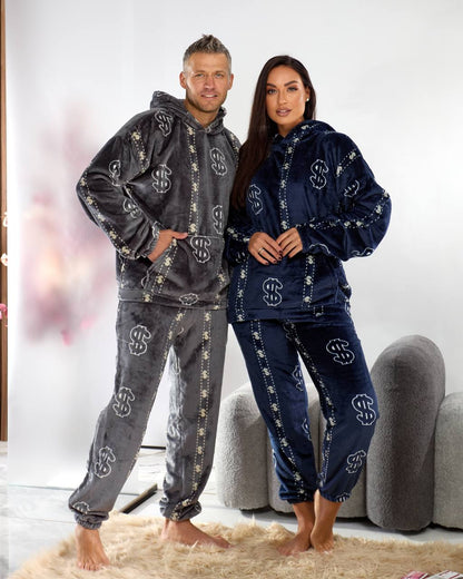 Two people wearing matching pajama sets in a living room.