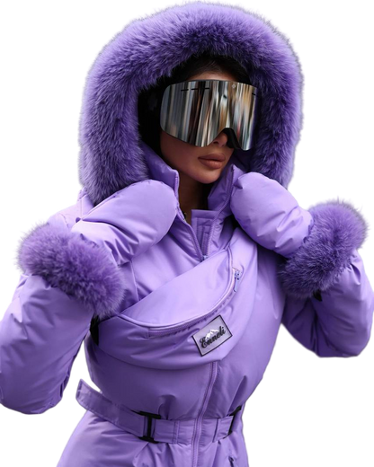 Person wearing a purple snowsuit with fur trim and goggles on a white background