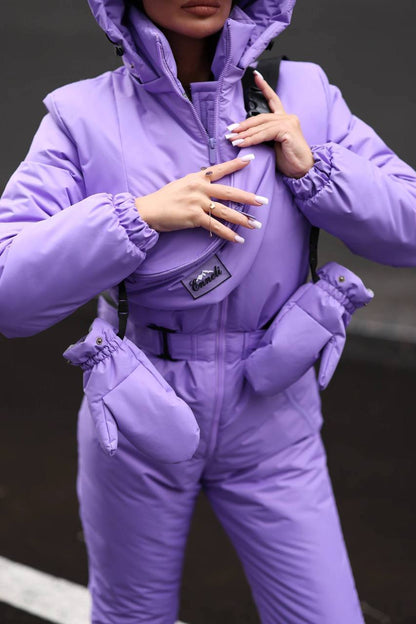 Person wearing a purple snowsuit with a hood and gloves on a dark background