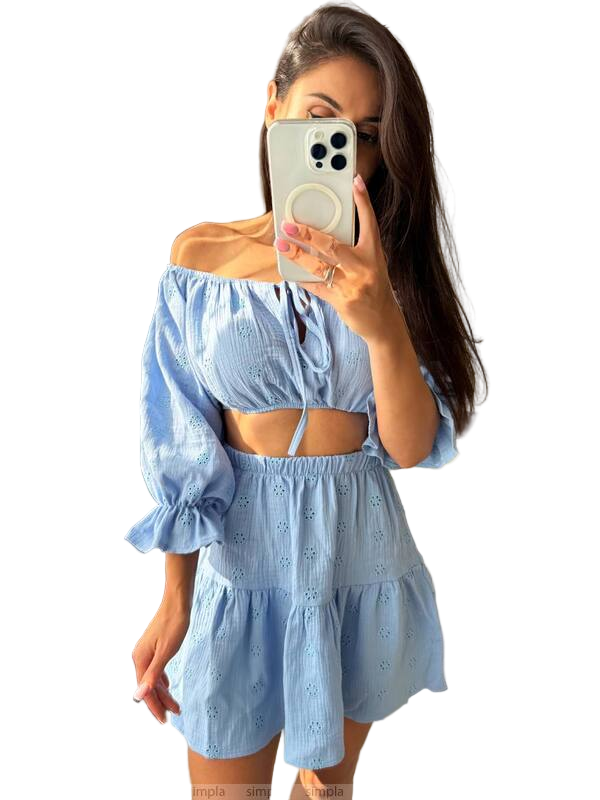 Woman wearing a light blue off-shoulder top and shorts set against a white background