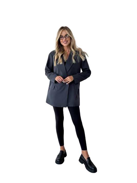 Woman wearing a gray coat and black pants on a white background