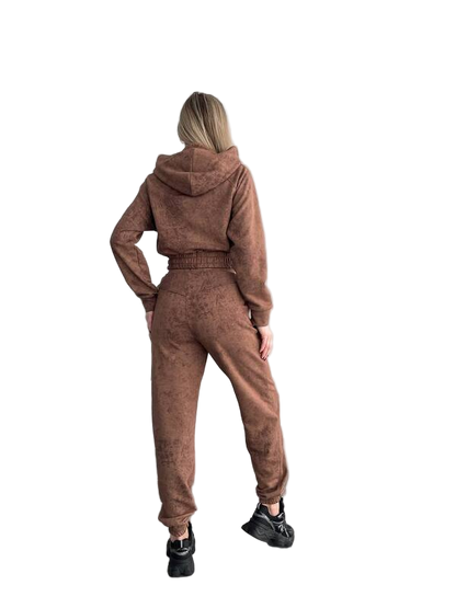 Person wearing a brown tracksuit from behind on a white background