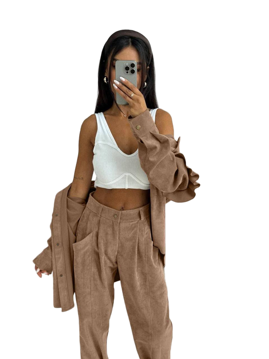 Person wearing a white top and brown pants with a matching jacket on a white background