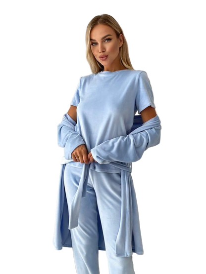 Woman wearing a light blue outfit with a matching jacket on a white background