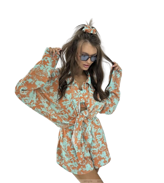 Woman wearing a floral dress with long sleeves on a white background