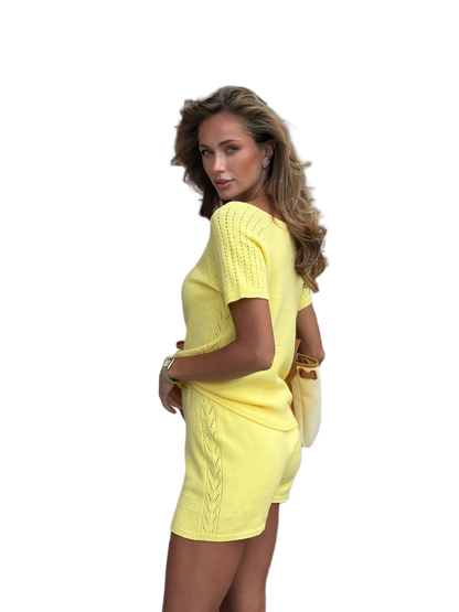 Woman wearing a yellow outfit on a white background
