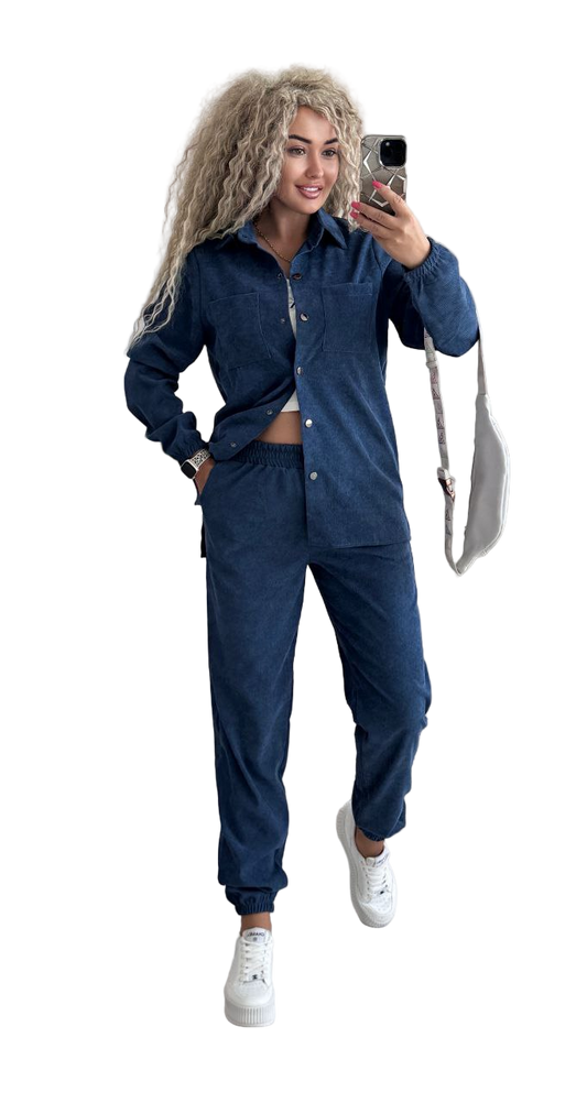 Woman taking a selfie wearing a blue tracksuit on a white background