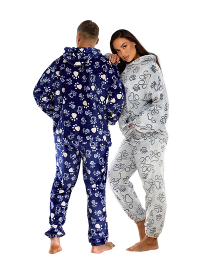 Two people wearing matching floral onesies on a white background