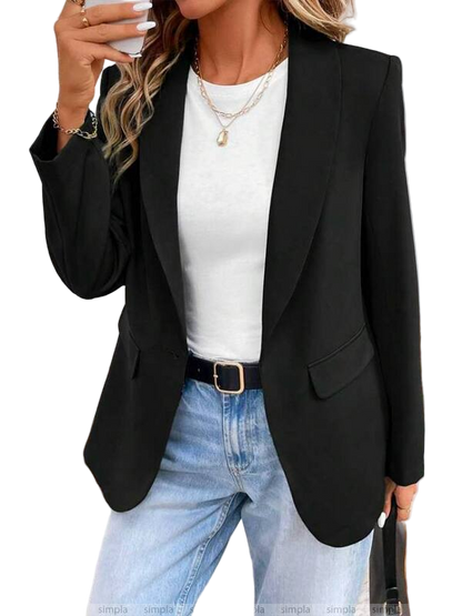 Person wearing a black blazer, white top, and blue jeans on a white background