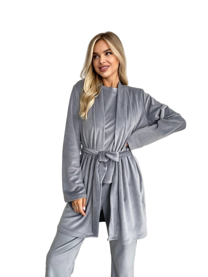 Woman wearing a gray robe with a belt on a white background