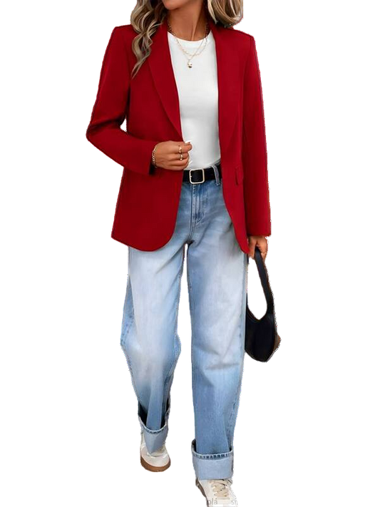 Person wearing a red blazer, white shirt, and blue jeans with a black handbag.