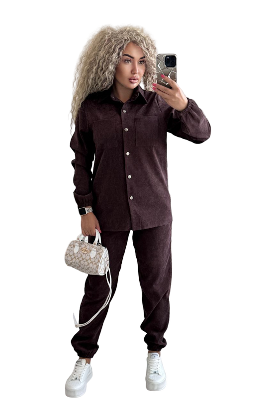 Woman taking a selfie wearing a brown corduroy outfit with a white background