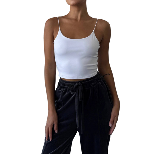 Person wearing a white tank top and black pants on a white background