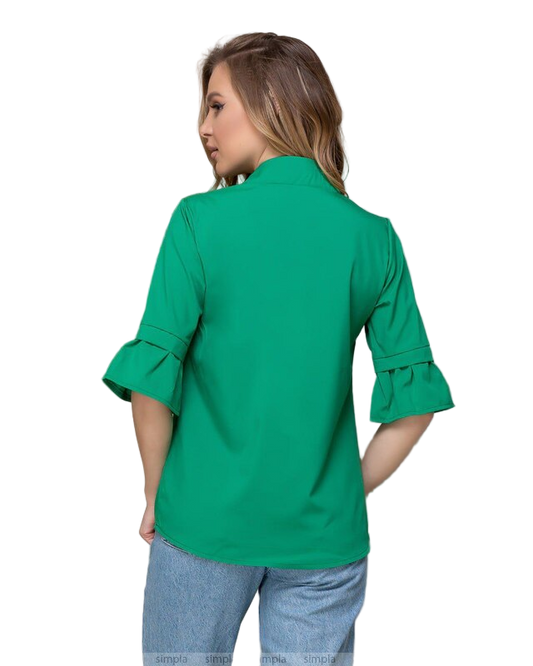 Woman wearing a green blouse with rolled-up sleeves on a white background