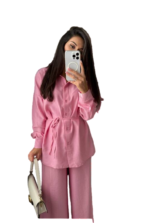 Person wearing a pink outfit taking a mirror selfie.