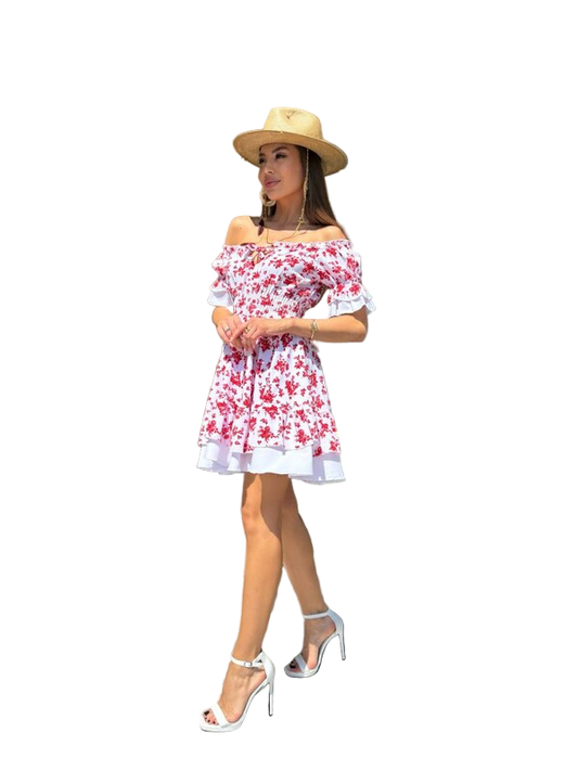 Woman wearing a floral off-shoulder dress and straw hat on a white background