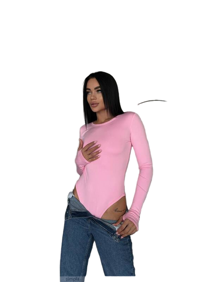 Woman wearing a pink long-sleeve top and blue jeans on a white background