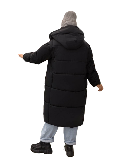 Person wearing a long black puffer coat on a white background