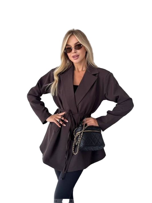Woman wearing a dark brown coat with a black handbag on a white background